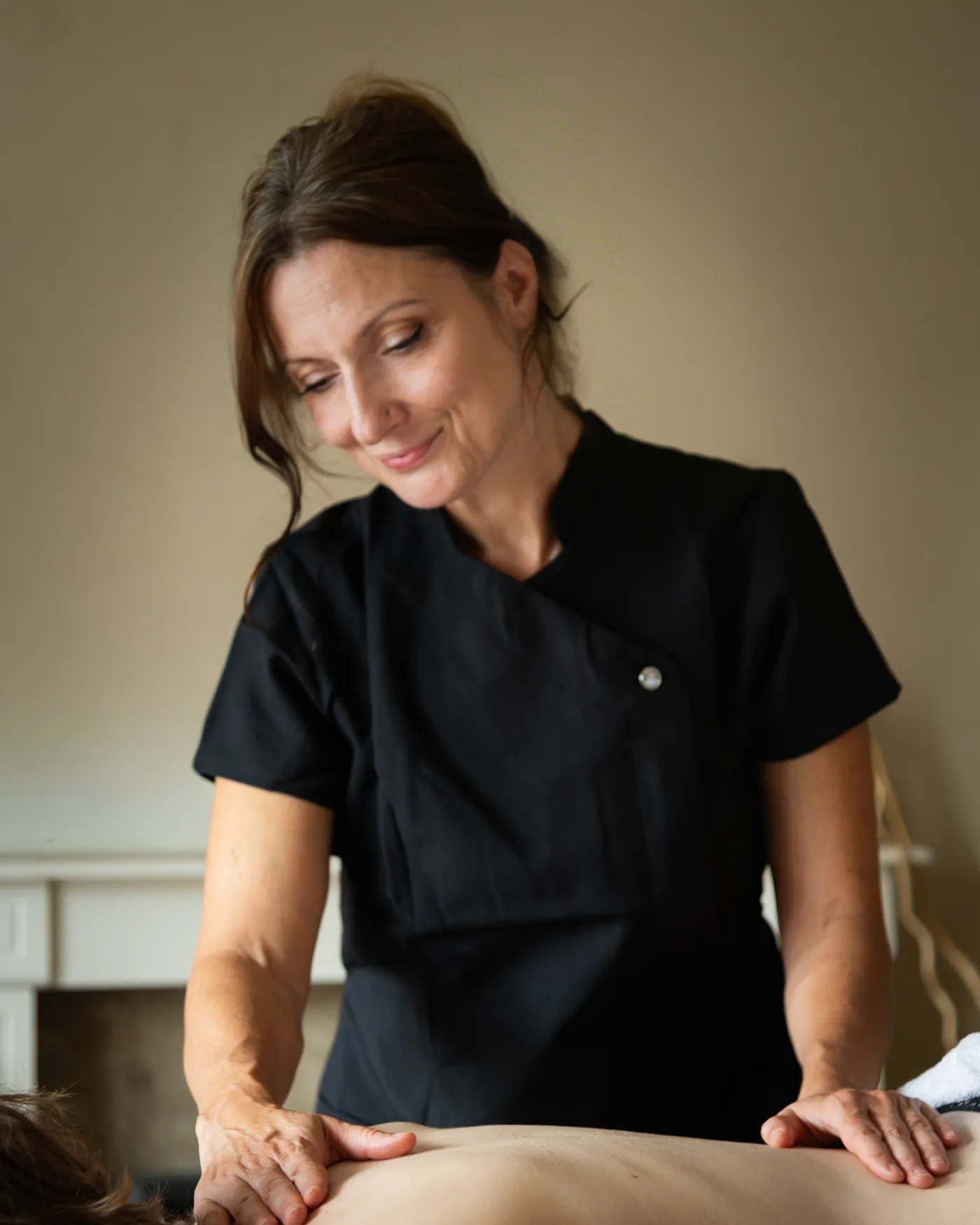 Iwona giving a back and shoulder massage in her treatment room