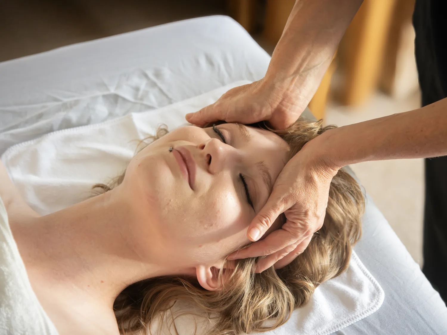 Gentle holistic head massage during a relaxation treatment